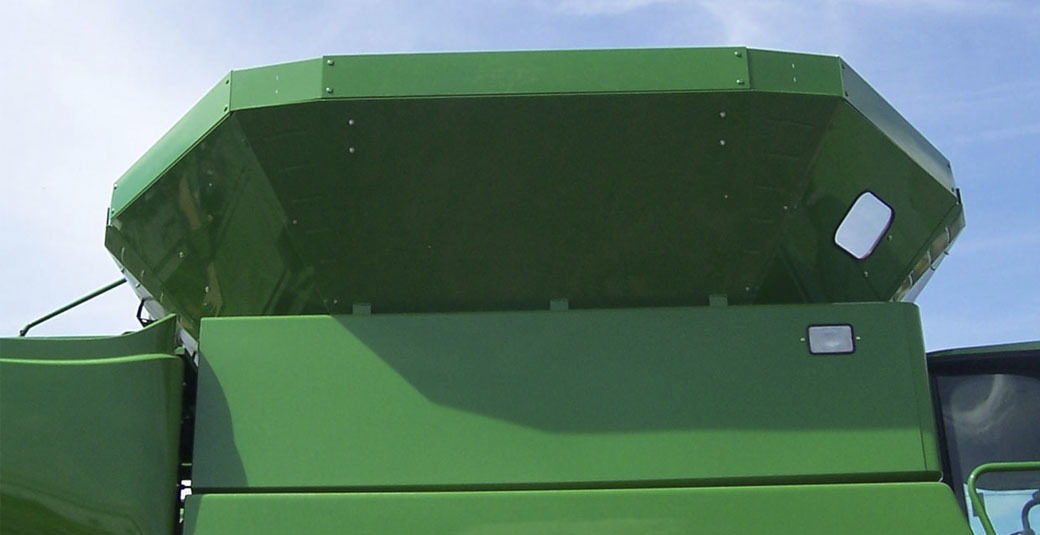 A green combine grain tank extension